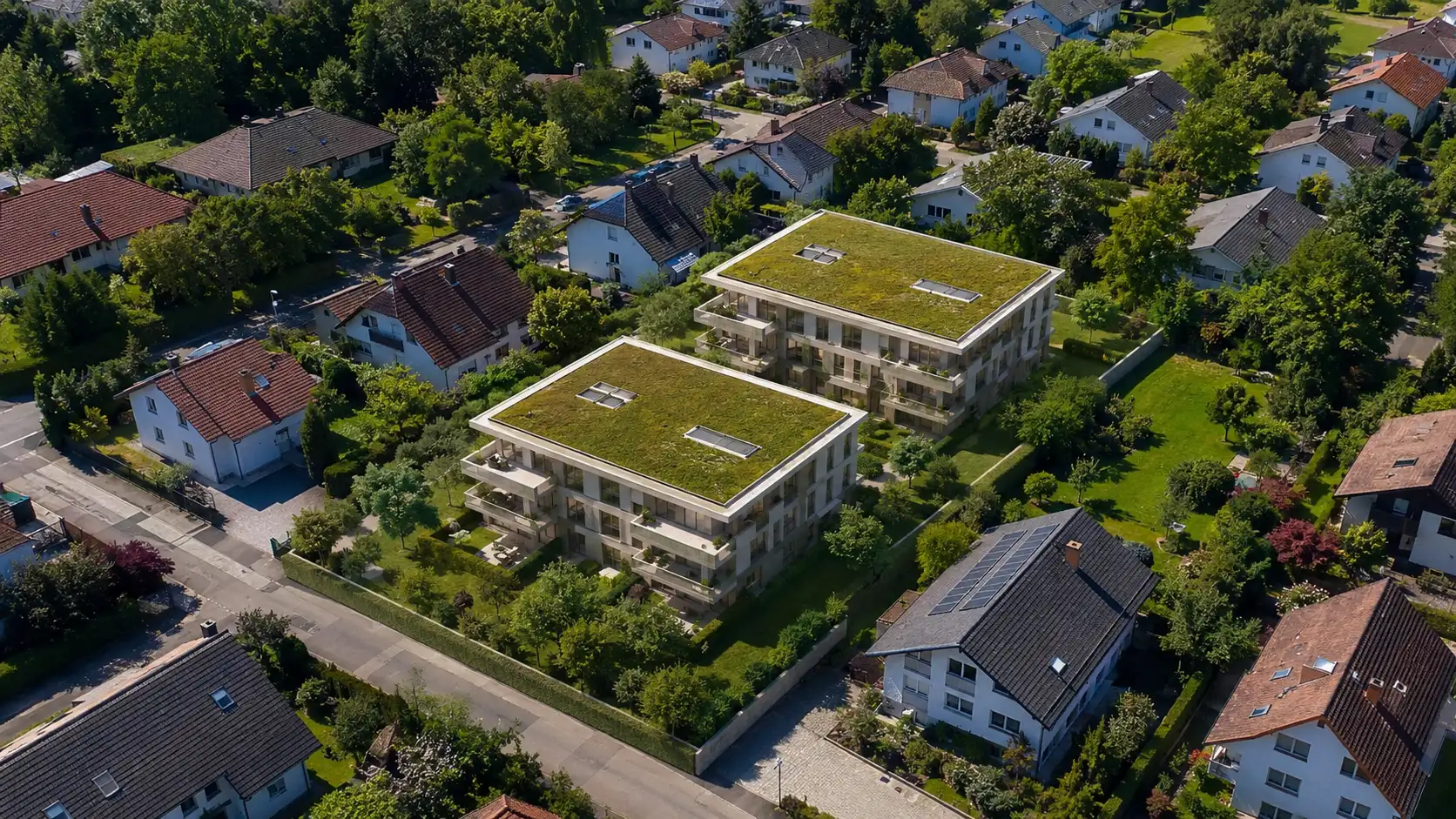 Neubauvertrieb München: Luftaufnahme eines Neubauprojekts mit zwei Mehrfamilienhäusern